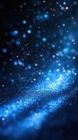 Delicate blue glitter particles shimmering in the dark with a mesmerizing depth creating an ethereal atmosphere photo