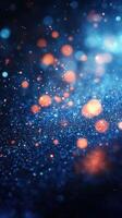 Colorful abstract background featuring shimmering particles and light effects in a deep blue and orange palette photo