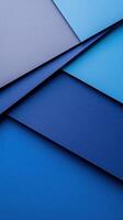 Layers of blue paper with varying shades creating a textured background in an artistic arrangement photo