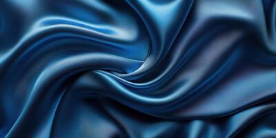 Luxurious deep blue silk fabric draping elegantly with soft folds and a glossy sheen in natural light photo