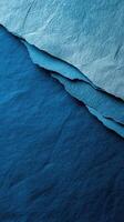 Shades of blue paper layered artfully to create a textured visual display photo