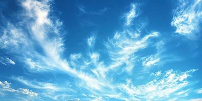 Beautiful wispy clouds display artistry against a bright blue sky during a sunny afternoon photo