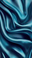 Beautiful blue silk fabric displaying luxurious texture and smooth drapes in elegant folds photo