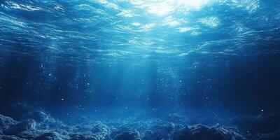 Sunlight filtering through the ocean surface creates a serene underwater atmosphere with soft blue tones photo