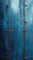 Textured blue metal panels with rivets in an industrial setting, showcasing weathered elegance and rustic charm photo