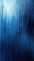Textured blue background displaying gradients and sheen with subtle light reflections in an abstract setting photo