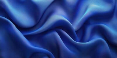 Elegant blue satin fabric draped softly in folds creating a luxurious texture and rich color in natural light photo