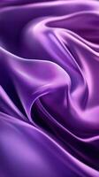 Soft flowing purple silk fabric creates an elegant texture in a richly colored surface, showcasing its smooth and lustrous quality photo