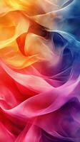 Colorful flowing fabric creates an abstract background with vibrant hues of orange, red, purple, and blue photo