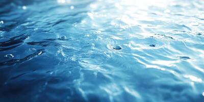 Rippling water surface with droplets reflecting sunlight in a serene environment photo