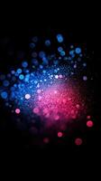 Vibrant blue and pink particle burst creating a mesmerizing visual effect at night photo