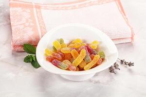 A bowl filled with gummy bears and a towel photo