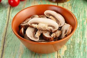 A bowl of mushrooms on a table photo