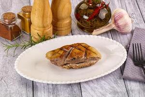 A plate of food on a table with a knife and fork photo