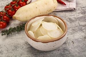 A bowl of potatoes and tomatoes on a table photo