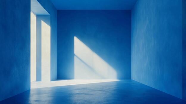 An empty blue room is illuminated by a large window where light streams into the space and creates an interesting triangle on the wall. photo
