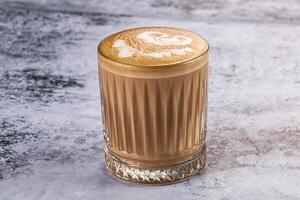 A latte with a heart design on top photo