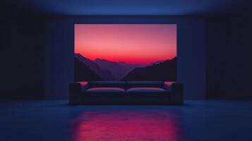 Couch is in a room with a large window that shows a beautiful mountain range with a pink and orange sunset photo