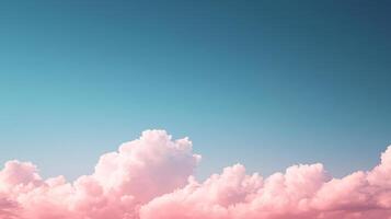 Pink clouds float across a teal blue sky, creating a serene and dreamy atmosphere photo