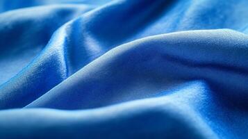 Luxurious blue silk fabric flowing and creating soft waves, perfect for backgrounds or design elements photo