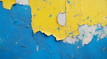 Peeling paint revealing layers of color and texture, creating an abstract pattern on a weathered surface with blue, yellow, and white hues. photo