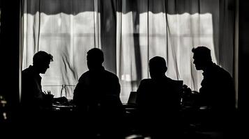 Silhouetted figures convene near a window, creating an atmosphere of focused discussion and strategic planning. photo