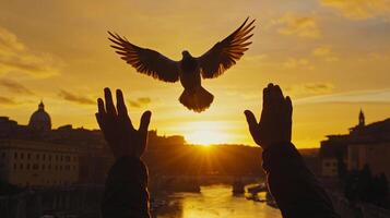 Bird soars over hands in Rome, bathed in golden sunset. Hope, freedom and peace as the bird takes flight against the city skyline. photo
