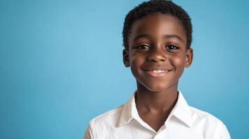 Smiling boy with warm, genuine expression, dressed in a white collared shirt against a plain blue background highlighting his cheerful demeanor. photo
