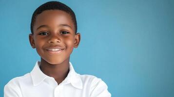 Portrait of a young boy against a blue background, wearing a white collared shirt, smiling gently at the viewer. Expressing hope and dreams. photo