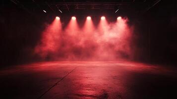 An empty performance stage illuminated with several bright red stage lights and low-lying fog effects creating a dramatic atmosphere. photo