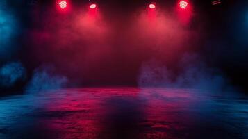Eerie stage scene bathed in red and blue lights, filled with low lying fog over reflective floor. Perfect atmosphere for an event. photo