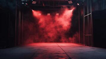Empty stage bathed in intense red light and atmospheric fog, ready for a powerful performance or dramatic scene. The ambiance is mysterious. photo