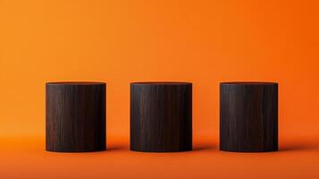 Three dark wooden cylindrical platforms on a vivid orange surface create a minimalist stage for product showcase or artistic display. photo