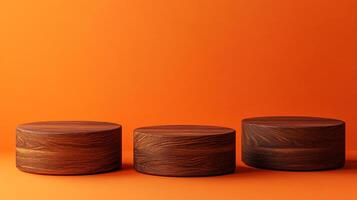 Three wooden pedestals stand in a row against an orange backdrop, each showcasing a unique wood grain pattern and minimalist design. photo