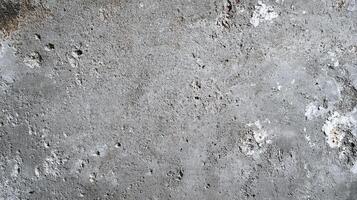 Abstract weathered concrete texture showcases wear and imperfections with varying tonal changes and surface disruptions on the surface. photo