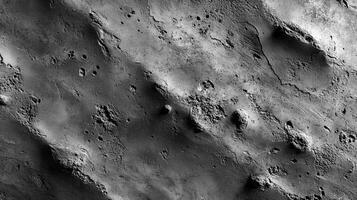 Textured surface of a celestial body shows craters, ridges, and shadows, suggesting ancient geological activity in a monochrome presentation. photo