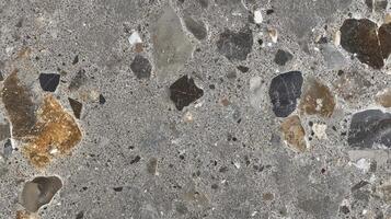 Detailed close-up of a terrazzo surface with a mix of stones, creating a textured and decorative ground, ideal for flooring and walls. photo