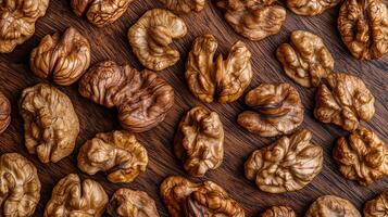 Walnut kernels on a wooden surface, showcasing their intricate textures and rich, natural color, creating an appetizing, healthy snack option. photo
