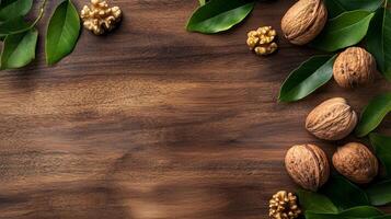 Walnuts and green leaves create a natural still life on a rich, dark wood surface, suggesting freshness and healthy eating. photo