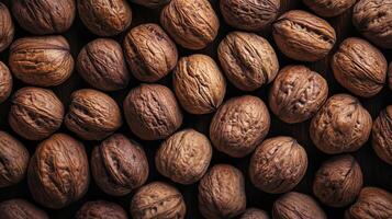 A captivating close-up showcases a collection of walnuts, highlighting their intricate textures and earthy tones, evoking a sense of natural richness. photo