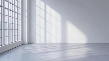 Bright, empty room with large windows. Light streams in, casting shadows on the floor and wall. A simple, serene space ready for design. photo