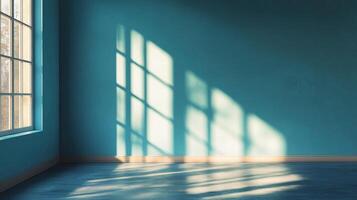 Sunlight through a window casts shadows in a blue room, creating a play of light and shadow. The room is simple and serene. photo