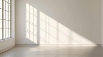 Sunlight streams through a window, casting an abstract pattern on the wall of an empty white room. The light reflects off the wooden floors. photo