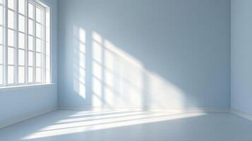 Bright, airy room painted pale blue with sunlight streaming in through a window, creating a pattern of light and shadow on the wall and floor. photo
