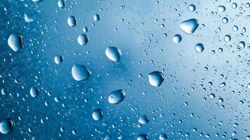 Macro shot of water droplets on a blue surface, creating a mesmerizing abstract pattern. Perfect for background or texture use. photo