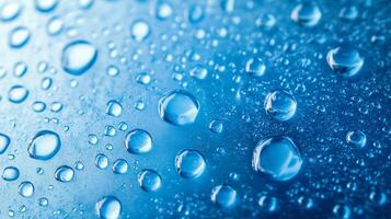 Close-up of water droplets on a blue surface, capturing their round shapes and light reflections. Water droplets on a smooth blue background. photo
