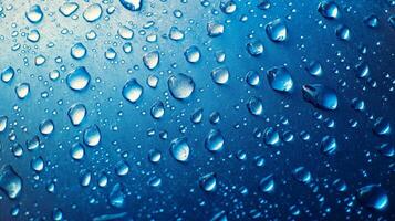 Macro shot of water droplets on a smooth, reflective blue surface. Highlights create a captivating play of light and shadow. photo