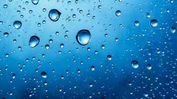 Raindrops on a vibrant blue surface create a mesmerizing pattern of light and reflection, capturing nature's artistic touch. photo