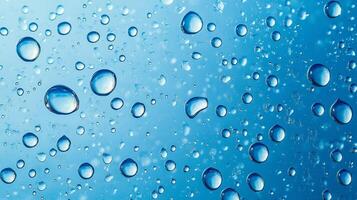 Macro image showcasing water droplets clinging to a blue surface, creating an abstract, refreshing, and visually appealing composition. photo