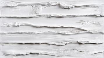 White painted planks create an abstract textural surface. Layers of paint, with varying thickness, are arranged horizontally. photo